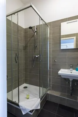 a bathroom with a shower and a sink at SlaBur Residence in Prague