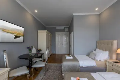 a bedroom with two beds and a table in it at SlaBur Residence in Prague