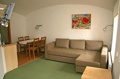 a living room with a couch and a table at Penzion Speller in Vysoký Újezd