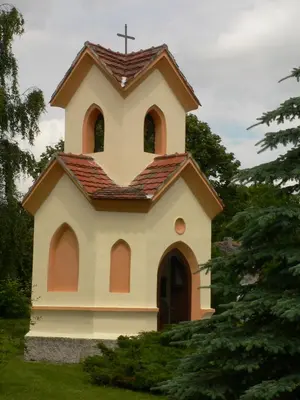 a small church with a cross on top of it at Penzion Speller in Vysoký Újezd