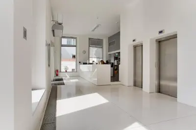 a living room with white walls and white floors at Teichmann Premium Apartments in Prague