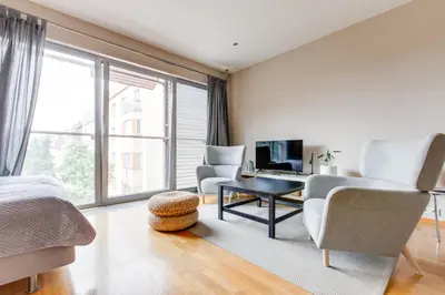 a bedroom with a bed and a desk and chairs at Teichmann Premium Apartments in Prague