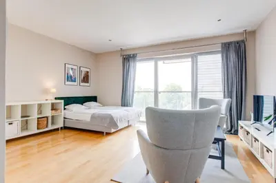 a bedroom with a bed and a chair at Teichmann Premium Apartments in Prague