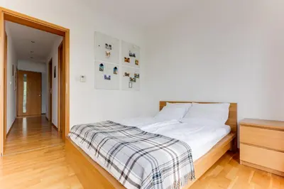 a bedroom with a bed with white sheets at Teichmann Premium Apartments in Prague