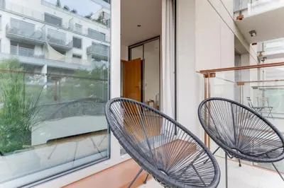 two chairs on a balcony with a window at Teichmann Premium Apartments in Prague