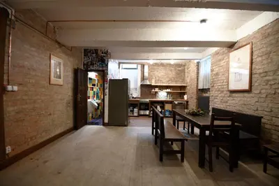 a kitchen and dining room with a table and chairs at Giotto Apartments in Prague