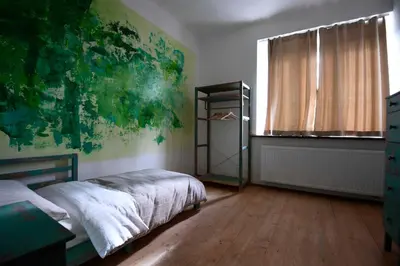 a bedroom with a bed and a large window at Giotto Apartments in Prague