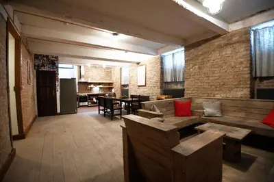 a living room with a couch and a dining room at Giotto Apartments in Prague