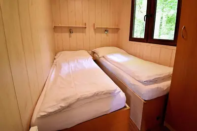 two bunk beds in a small room with a window at Apartmány & Kemp Sázavský ostrov in Sázava