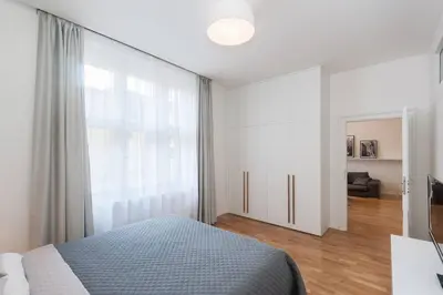 a bedroom with a bed and a large window at Wishlist Prague Residences - Old Town Dlouha in Prague