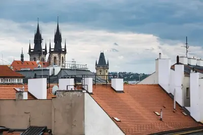 a view of the roofs of a city with cathedral at Wishlist Prague Residences - Old Town Dlouha in Prague