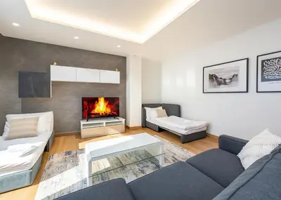 a living room with a couch and a fireplace at Wishlist Prague Residences - Old Town Dlouha in Prague