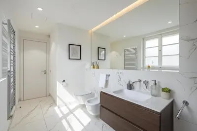 a white bathroom with a sink and a toilet at Wishlist Prague Residences - Old Town Dlouha in Prague