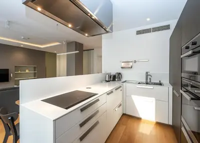 a white kitchen with a sink and a stove at Wishlist Prague Residences - Old Town Dlouha in Prague