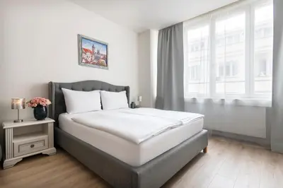 a bedroom with a large bed and a window at Prague Serenity Suites and Apartments in Prague
