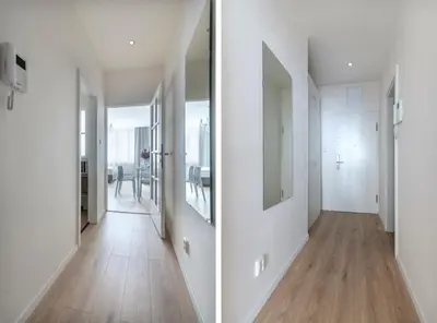 an empty hallway with white walls and wood floors at Prague Serenity Suites and Apartments in Prague