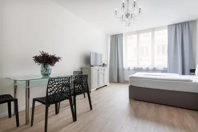a bedroom with a bed and a table and chairs at Prague Serenity Suites and Apartments in Prague