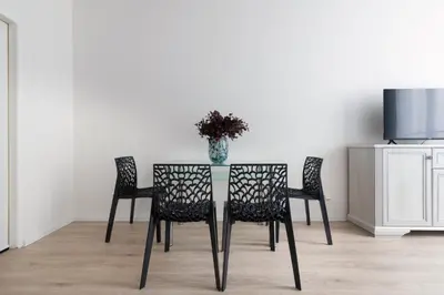 a table with two chairs and a vase on it at Prague Serenity Suites and Apartments in Prague