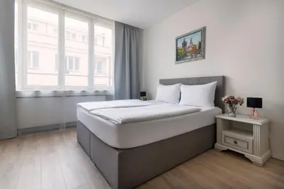 a bedroom with a large bed and a window at Prague Serenity Suites and Apartments in Prague