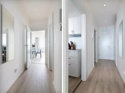 a kitchen with white cabinets and a wooden floor at Prague Serenity Suites and Apartments in Prague