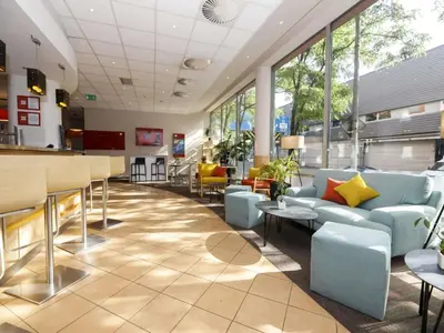 a waiting room with chairs and a table at Ibis Praha Mala Strana in Prague