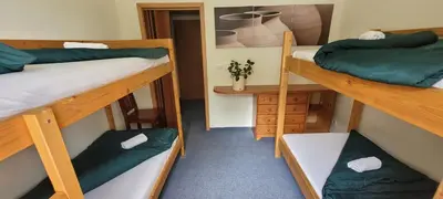 a room with two bunk beds and a hallway at Pension Patanka in Prague