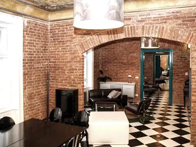 a brick bathroom with a shower and a sink at Old Town - Dusni Apartments in Prague