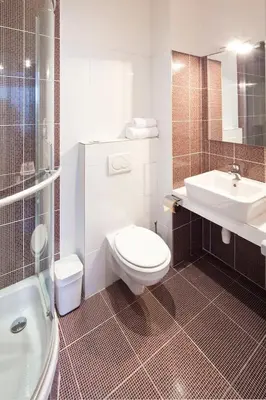 a kitchen with sinks and a brick wall at Old Town - Dusni Apartments in Prague