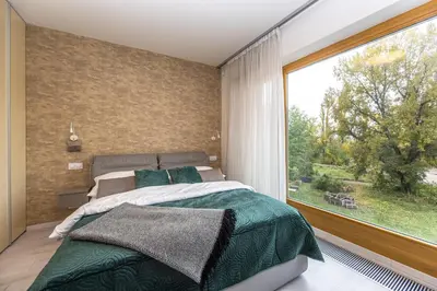 a bedroom with a bed and a large window at Wishlist Prague Residences - Karlín FREE PARKING in Prague