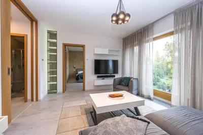 a living room with a couch and a table at Wishlist Prague Residences - Karlín FREE PARKING in Prague