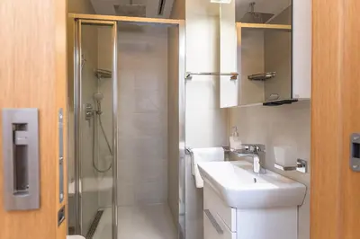 a bathroom with a sink and a shower at Wishlist Prague Residences - Karlín FREE PARKING in Prague