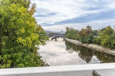 a view of a river with a bridge in the background at Wishlist Prague Residences - Karlín FREE PARKING in Prague