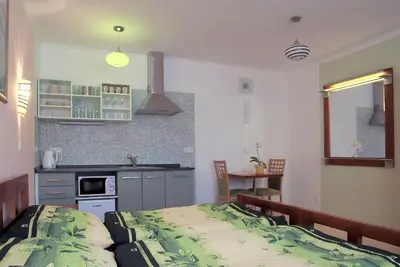 a small kitchen with a bed in a room at Penzion U Vinotéky in Nymburk