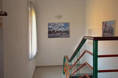 a staircase in a room with a picture on the wall at Penzion U Vinotéky in Nymburk