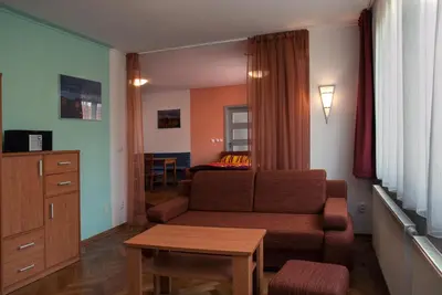 a living room with a couch and a table at Penzion U Vinotéky in Nymburk