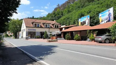an empty street in a small town with buildings at Bunkr Karlštejn - Modrý dům in Karlštejn