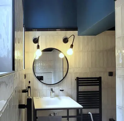 a bathroom with a sink and a mirror at Bunkr Karlštejn - Modrý dům in Karlštejn