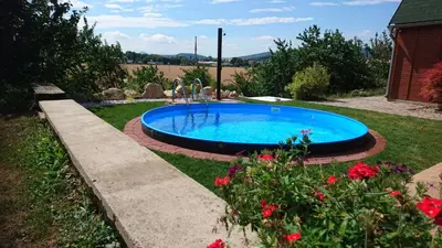 a swimming pool in a yard with flowers at Na vyhlidce in Litoměřice