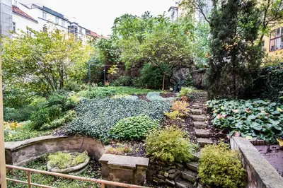 a garden with rocks and plants and trees at 3BDR City Center Ruterra Apartment in Prague