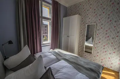 a bedroom with a bed and a window at 3BDR City Center Ruterra Apartment in Prague