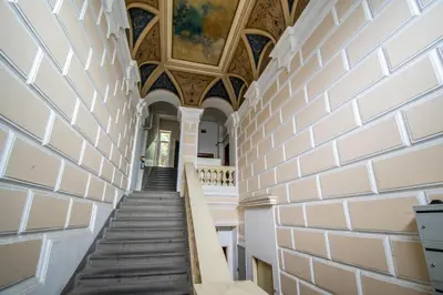 a hallway with stairs in a building with a ceiling at 3BDR City Center Ruterra Apartment in Prague