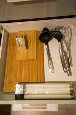 a kitchen counter with utensils on a cutting board at 3BDR City Center Ruterra Apartment in Prague