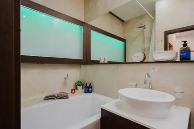 a bathroom with a large white tub and a sink at Prague Days - Open-plan Apartment with Netflix in Žižkov in Prague