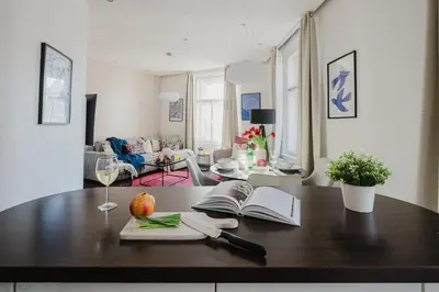 a living room with a table with an open book at Prague Days - Open-plan Apartment with Netflix in Žižkov in Prague