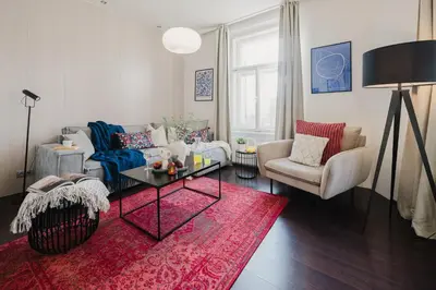 a living room with a couch and a table at Prague Days - Open-plan Apartment with Netflix in Žižkov in Prague