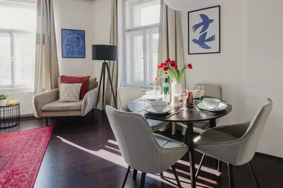 a dining room with a table and chairs at Prague Days - Open-plan Apartment with Netflix in Žižkov in Prague