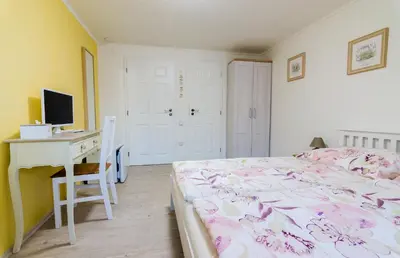 a bedroom with a bed and a desk and a computer at Guesthouse SaM in Roudnice nad Labem