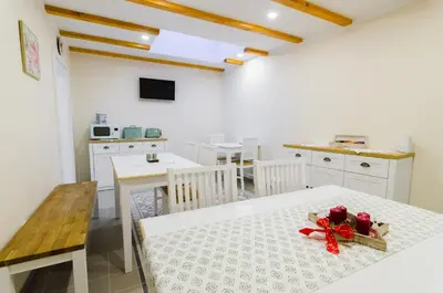 a kitchen and dining room with a table with a bow on it at Guesthouse SaM in Roudnice nad Labem