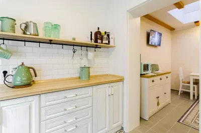 a kitchen with white cabinets and a counter at Guesthouse SaM in Roudnice nad Labem