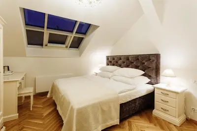 a bedroom with a bed and two windows at High Heaven in Prague